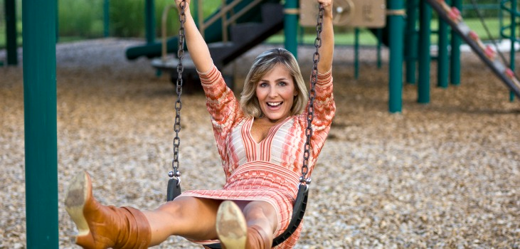mature blonde woman playing in swing